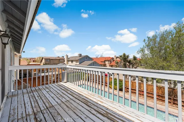a view of a balcony with wooden floor