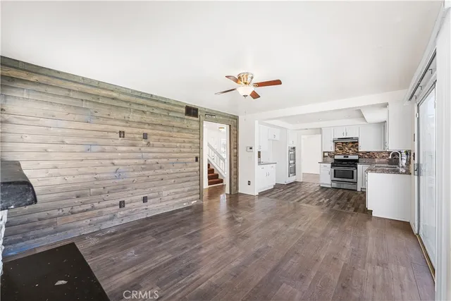 a view of kitchen and hall with wooden floor