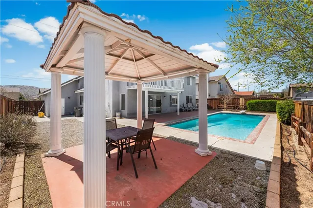a view of a house with backyard porch and sitting area