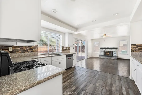 a kitchen with a stove a sink and a refrigerator