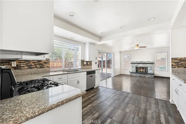 a kitchen with a stove a sink and a refrigerator