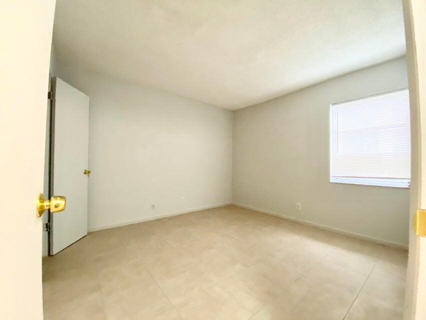 626 Northwest 13th Street, Unit 16 Boca Raton, FL 33486 - Photo 6 of 10 an empty room with a window