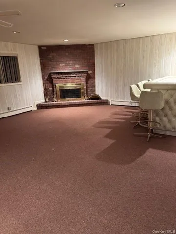 an empty room with fireplace and a window