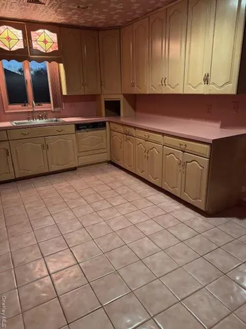 a kitchen with cabinets and window