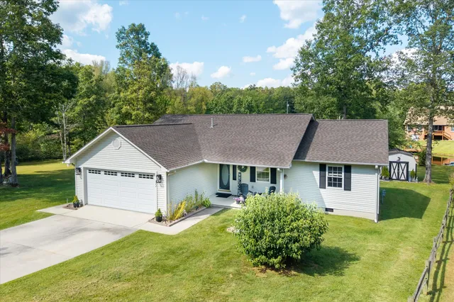 a front view of a house with a garden and plants