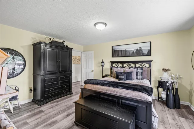 a bedroom with furniture and wooden floor