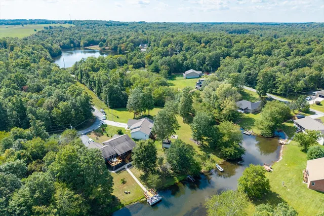 an aerial view of a house with swimming pool and garden