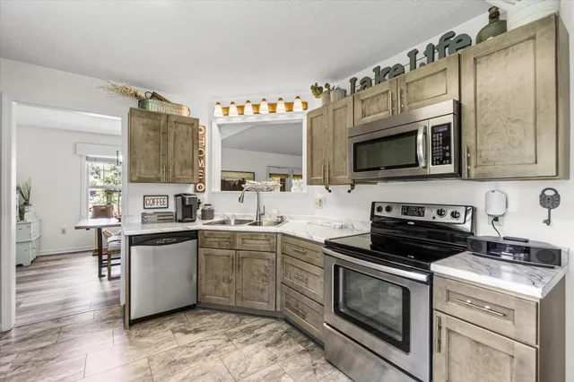 a kitchen with a sink stove and microwave