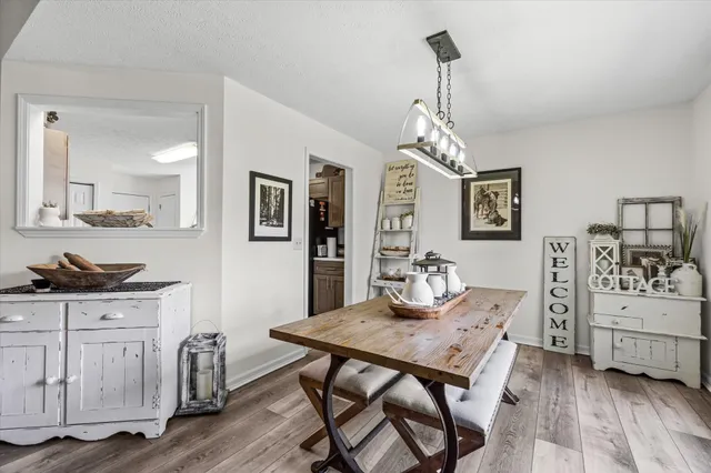 a view of a dining room with furniture and chandelier