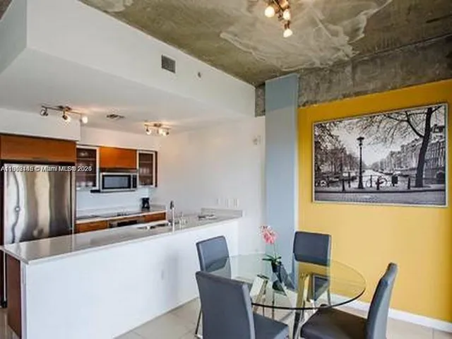 a dining room with furniture and window