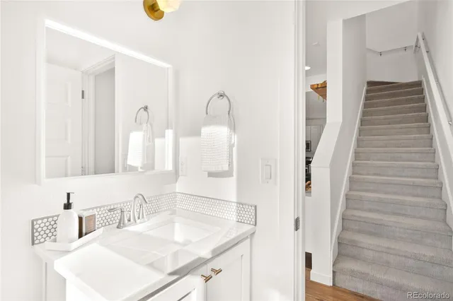 a bathroom with a sink vanity and a mirror