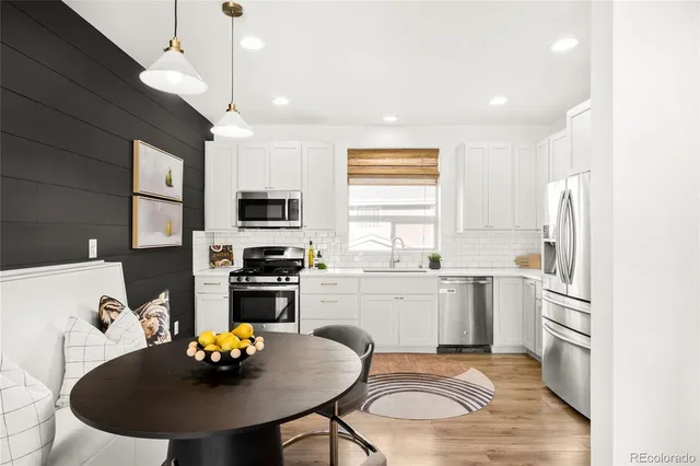 a kitchen with a sink appliances and cabinets