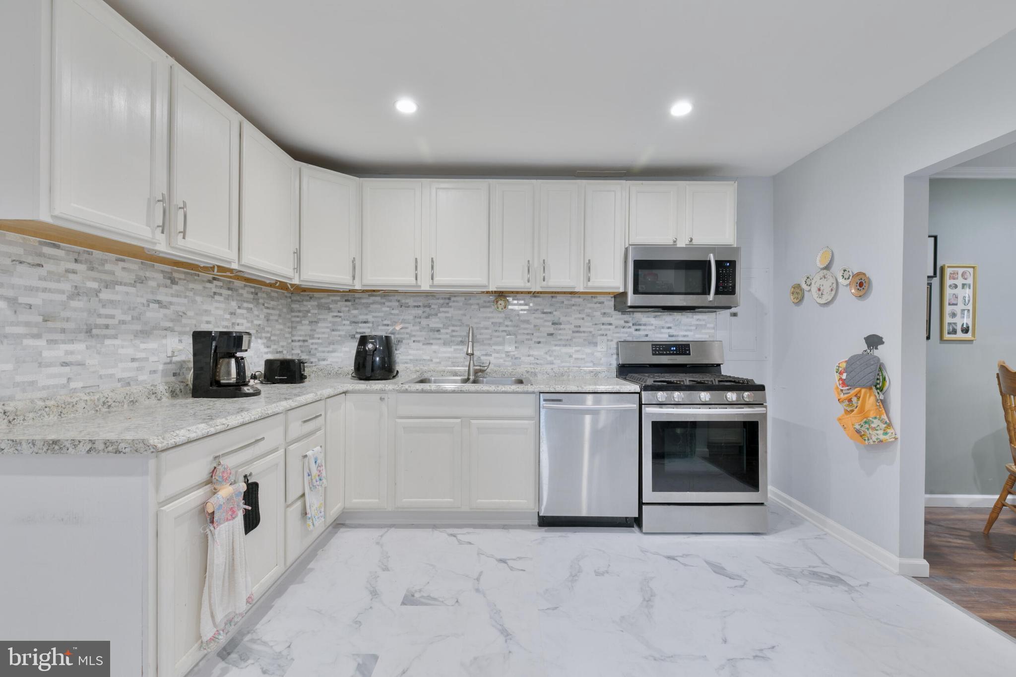 540 Eagle Place Winchester, VA 22601 - Photo 5 of 24 a kitchen with stainless steel appliances granite countertop a sink and a stove