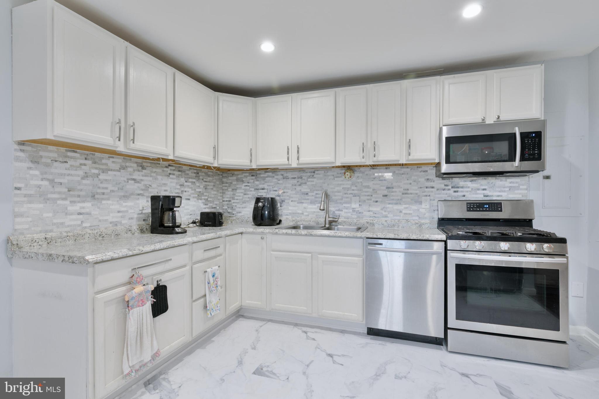540 Eagle Place Winchester, VA 22601 - Photo 6 of 24 a kitchen with white cabinets stainless steel appliances and sink