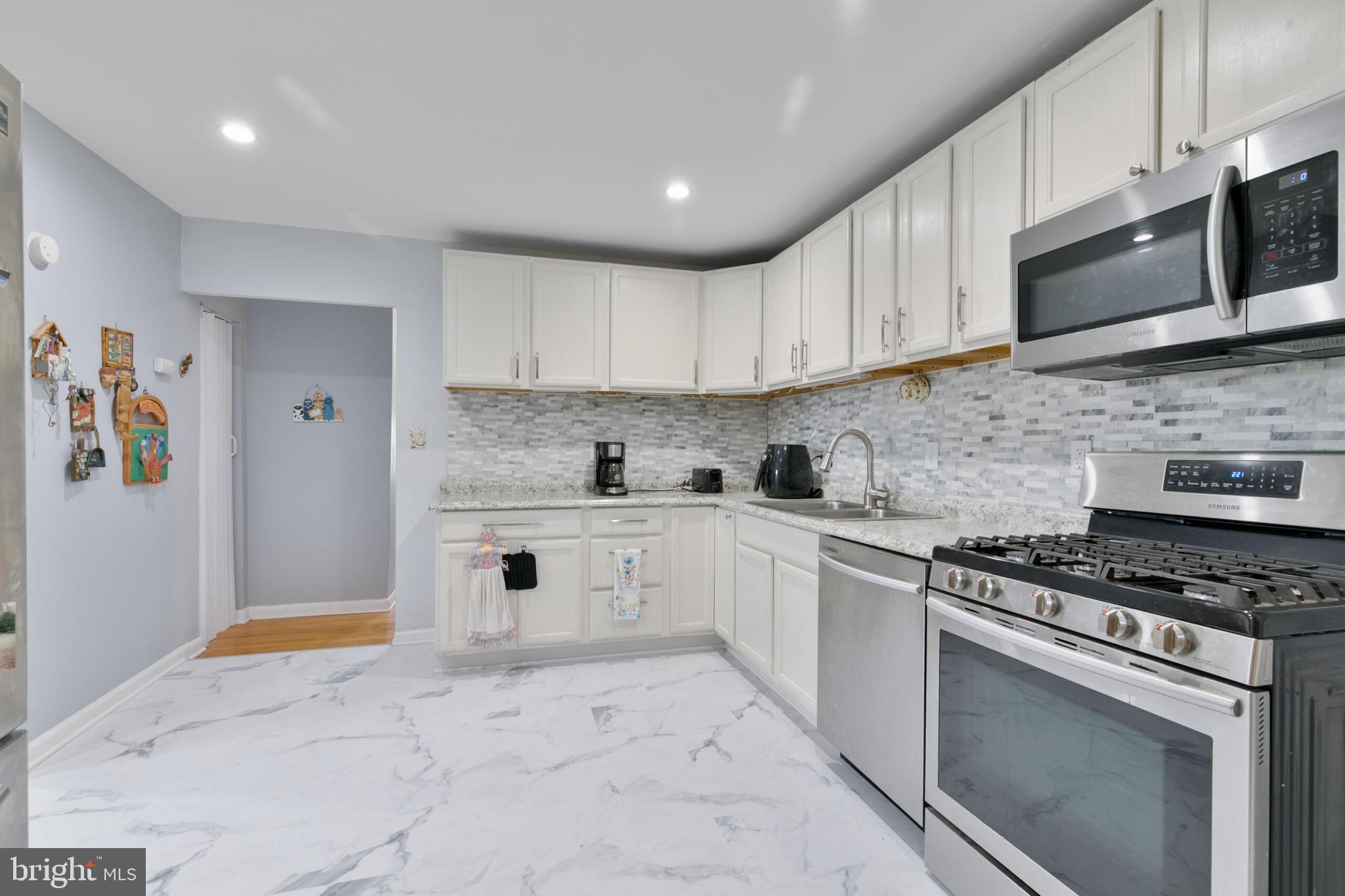 540 Eagle Place Winchester, VA 22601 - Photo 7 of 24 a kitchen with granite countertop white cabinets stainless steel appliances and a sink