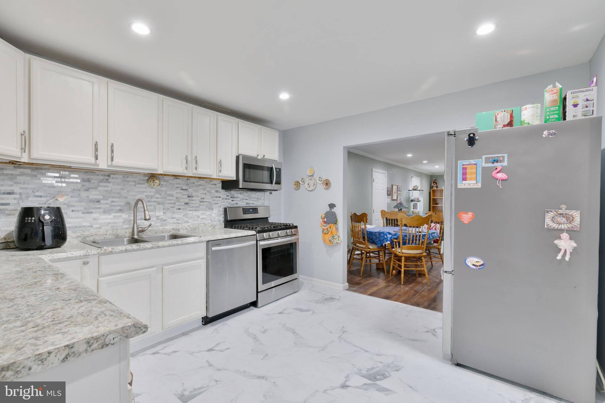 540 Eagle Place Winchester, VA 22601 - Photo 8 of 24 a kitchen with white cabinets and stainless steel appliances