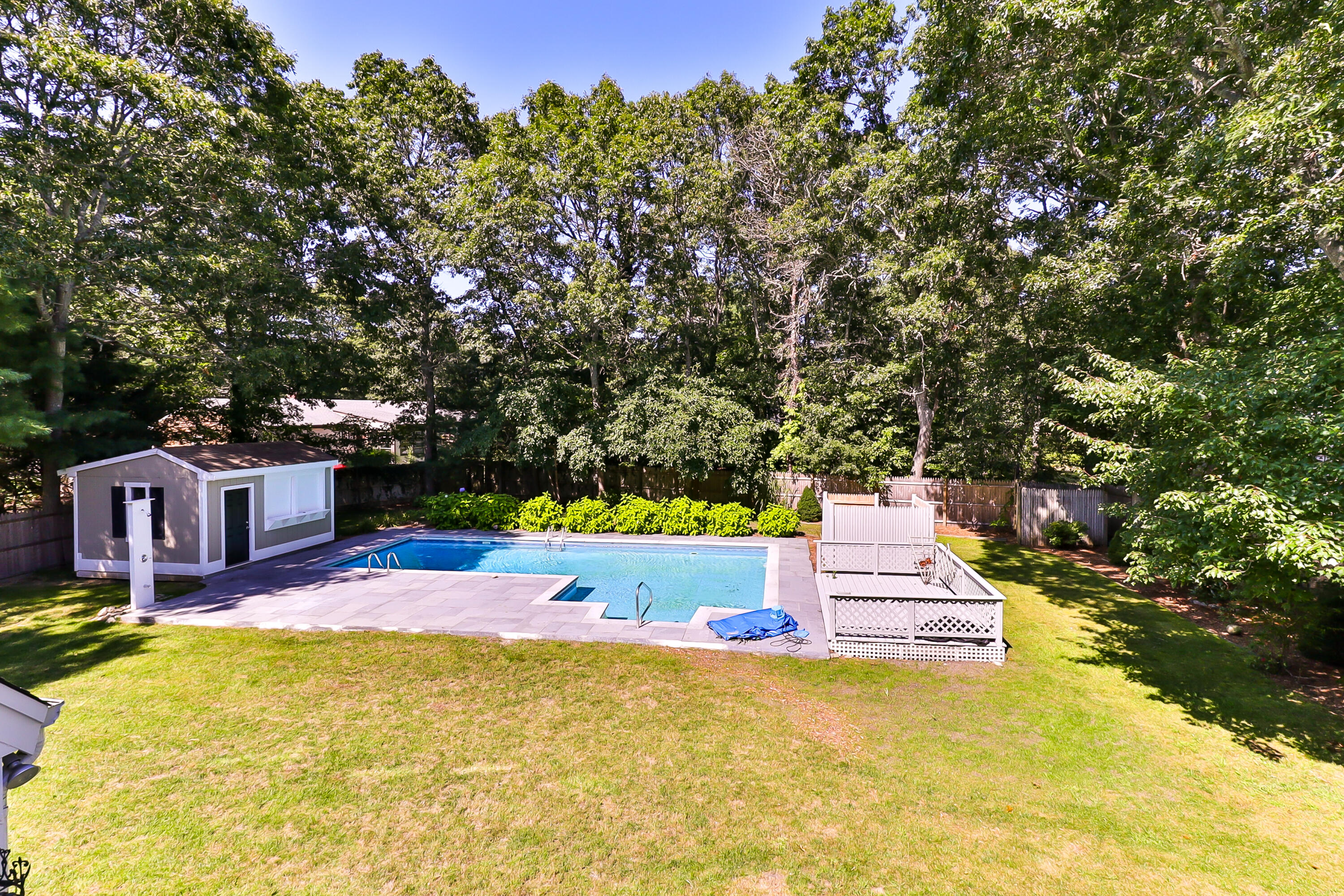 138 Lumbert Mill Road Centerville, MA 02632 - Photo 16 of 29 a swimming pool with trees in the background