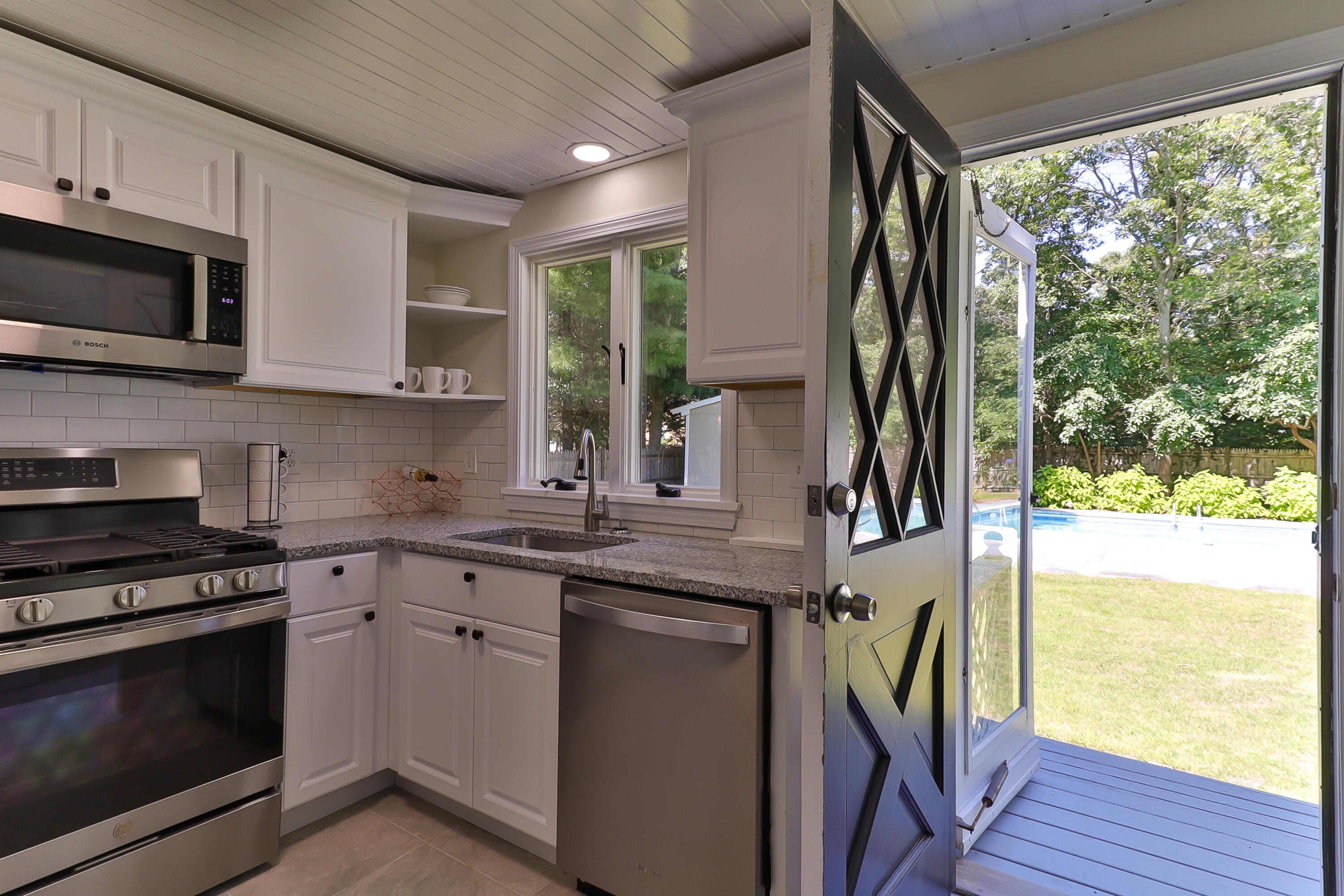 138 Lumbert Mill Road Centerville, MA 02632 - Photo 7 of 29 a kitchen with a stove a sink and a microwave