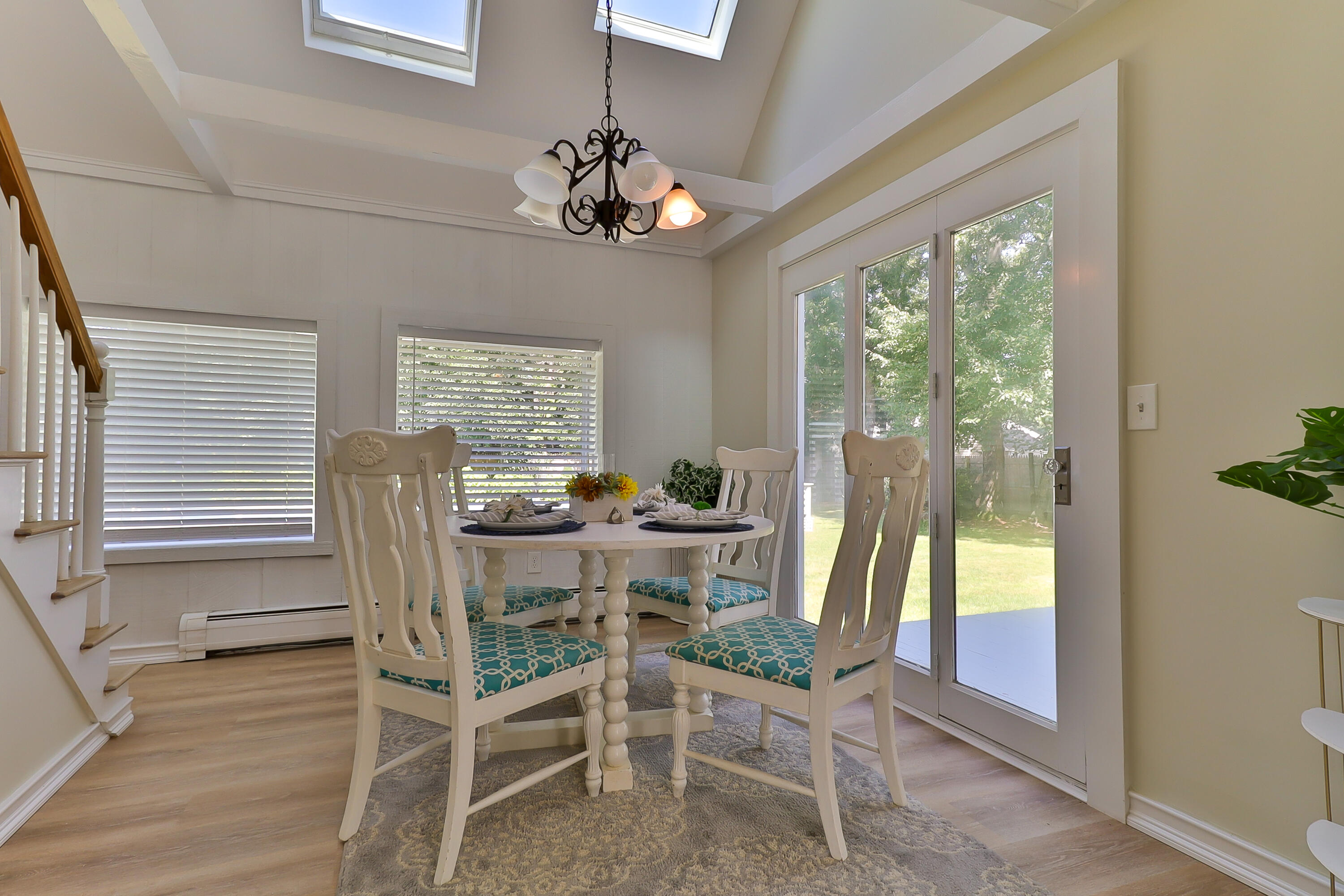 138 Lumbert Mill Road Centerville, MA 02632 - Photo 8 of 29 a view of a dining room with furniture wooden floor and chandelier