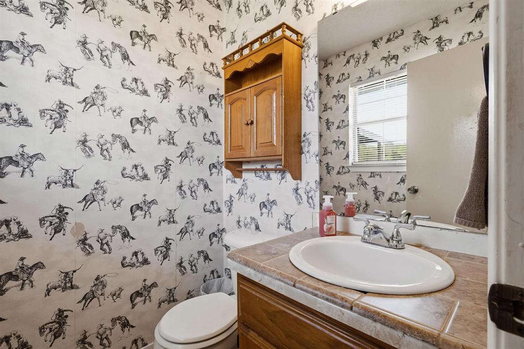 472 Milton-Minter Road Deport, TX 75435 - Photo 16 of 30 a bathroom with a sink a toilet and a mirror