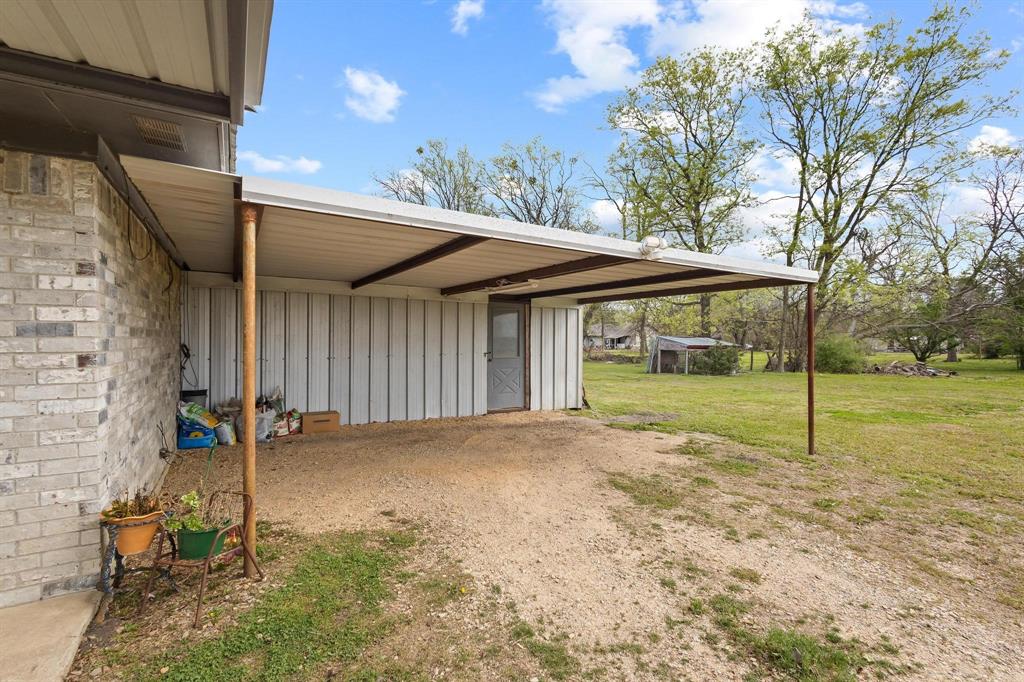 472 Milton-Minter Road Deport, TX 75435 - Photo 24 of 30 a view of a house with backyard and trees