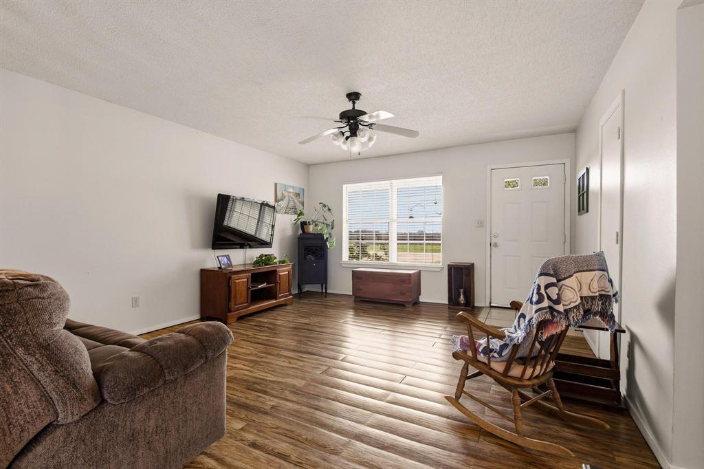 472 Milton-Minter Road Deport, TX 75435 - Photo 3 of 30 a living room with furniture a fireplace a flat screen tv and windows