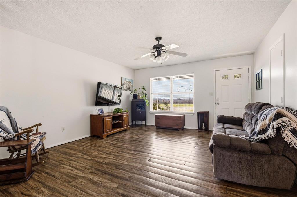 472 Milton-Minter Road Deport, TX 75435 - Photo 6 of 30 a living room with furniture wooden floor and a view of kitchen