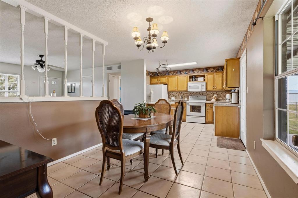 472 Milton-Minter Road Deport, TX 75435 - Photo 9 of 30 a dining room with furniture and chandelier