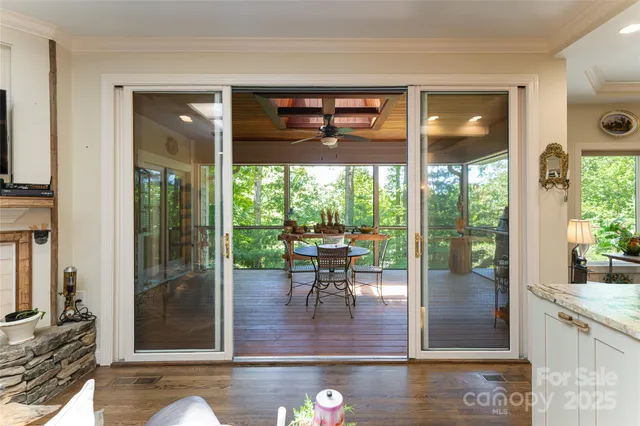 a dining room with wooden floor and a floor to ceiling window