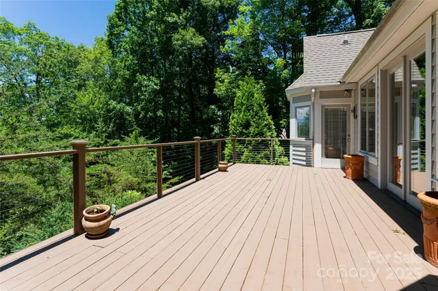 a view of balcony with wooden floor and outdoor seating