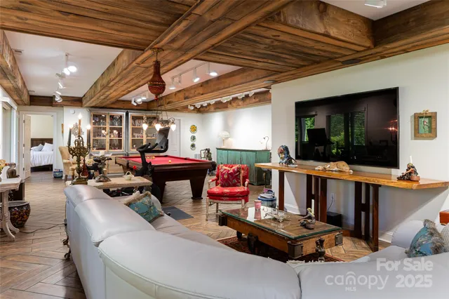 a room with pool table and windows