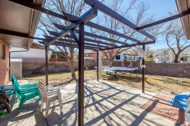 3334 Ute Road St. George, UT 84790 - Photo 34 of 40 Fenced backyard featuring a patio, a pergola, and a trampoline