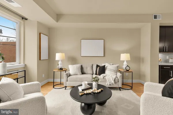 a living room with furniture and a lamp