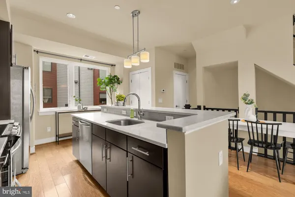a kitchen with center island table and chairs
