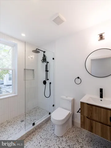a bathroom with a toilet sink shower and mirror