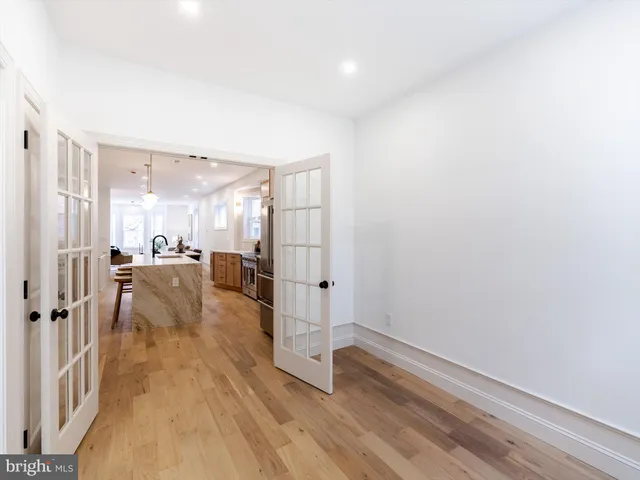 a view of a living room hardwood floor and a kitchen