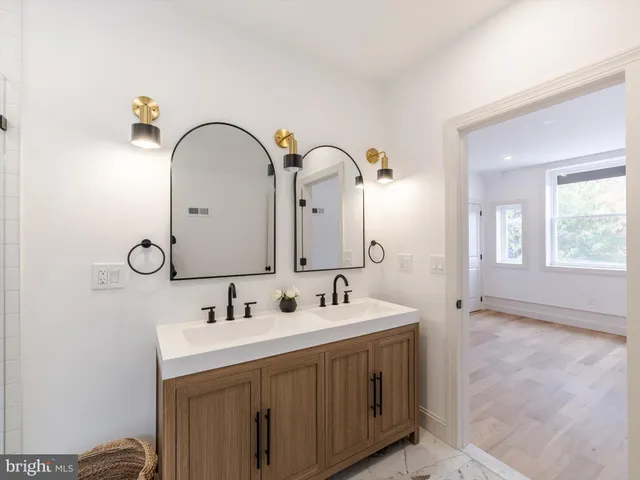 a bathroom with a double vanity sink and a mirror