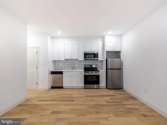 a kitchen with stainless steel appliances a refrigerator and a stove
