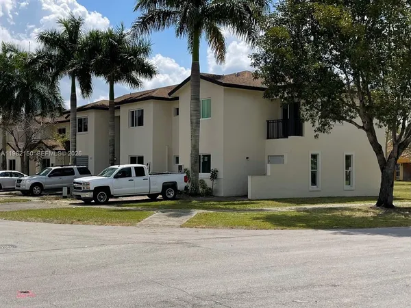 a view of a house with swimming pool and a car parked in front of it