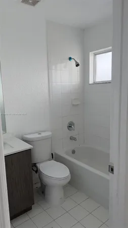 a white toilet sitting next to a bath tub