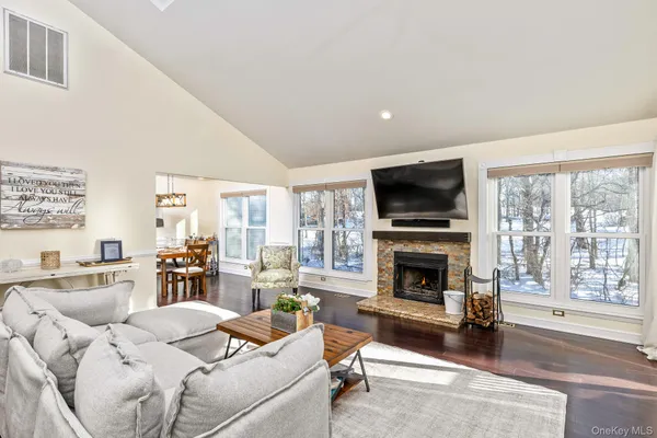 a living room with furniture a rug and a table
