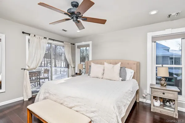 a large bedroom with a large bed and a chandelier