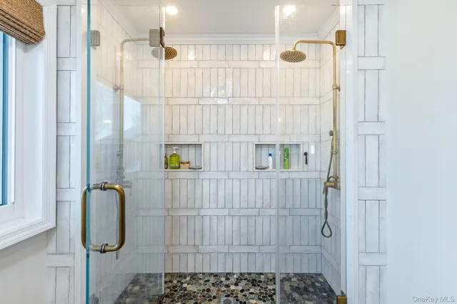 a bathroom with a double vanity sink and a mirror
