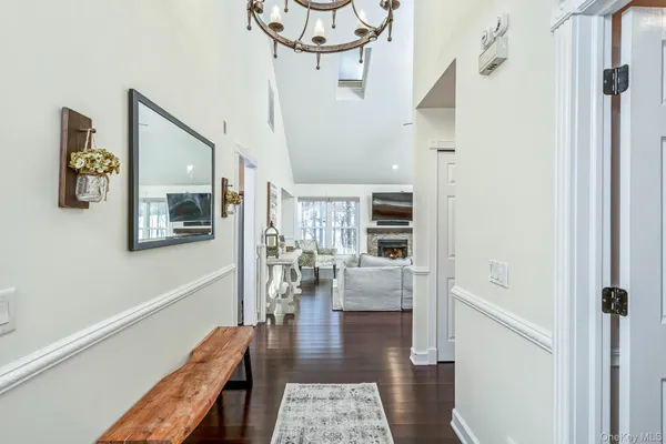 a view of a hallway with wooden floor and dining room