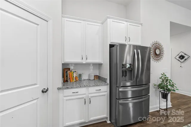 a kitchen with stainless steel appliances a refrigerator and cabinets