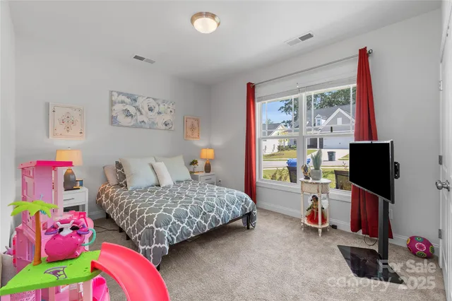 a bedroom with bed and a window