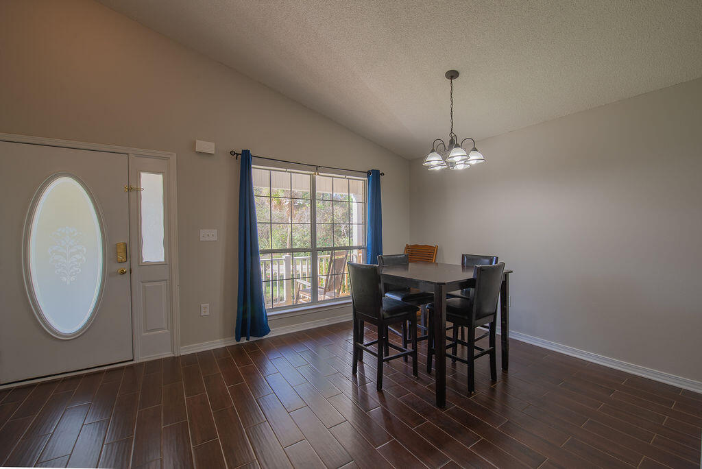 903 Lajolla Lane Mary Esther, FL 32569 - Photo 11 of 47 a view of a dining room with furniture window and wooden floor