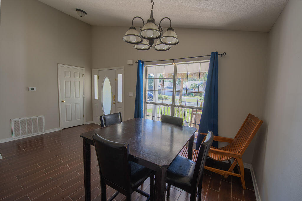 903 Lajolla Lane Mary Esther, FL 32569 - Photo 12 of 47 a view of a dining room with furniture window and wooden floor