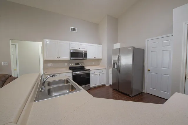 a kitchen with a refrigerator sink and microwave