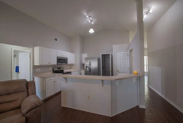 a kitchen with stainless steel appliances kitchen island sink refrigerator and stove